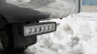 LED reversing light together with mounting hardware for mounting on VW Amarok from 2011-